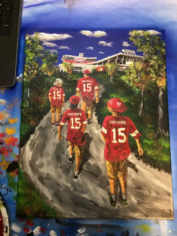 A painting of the kansas city chiefs on a dirt road.