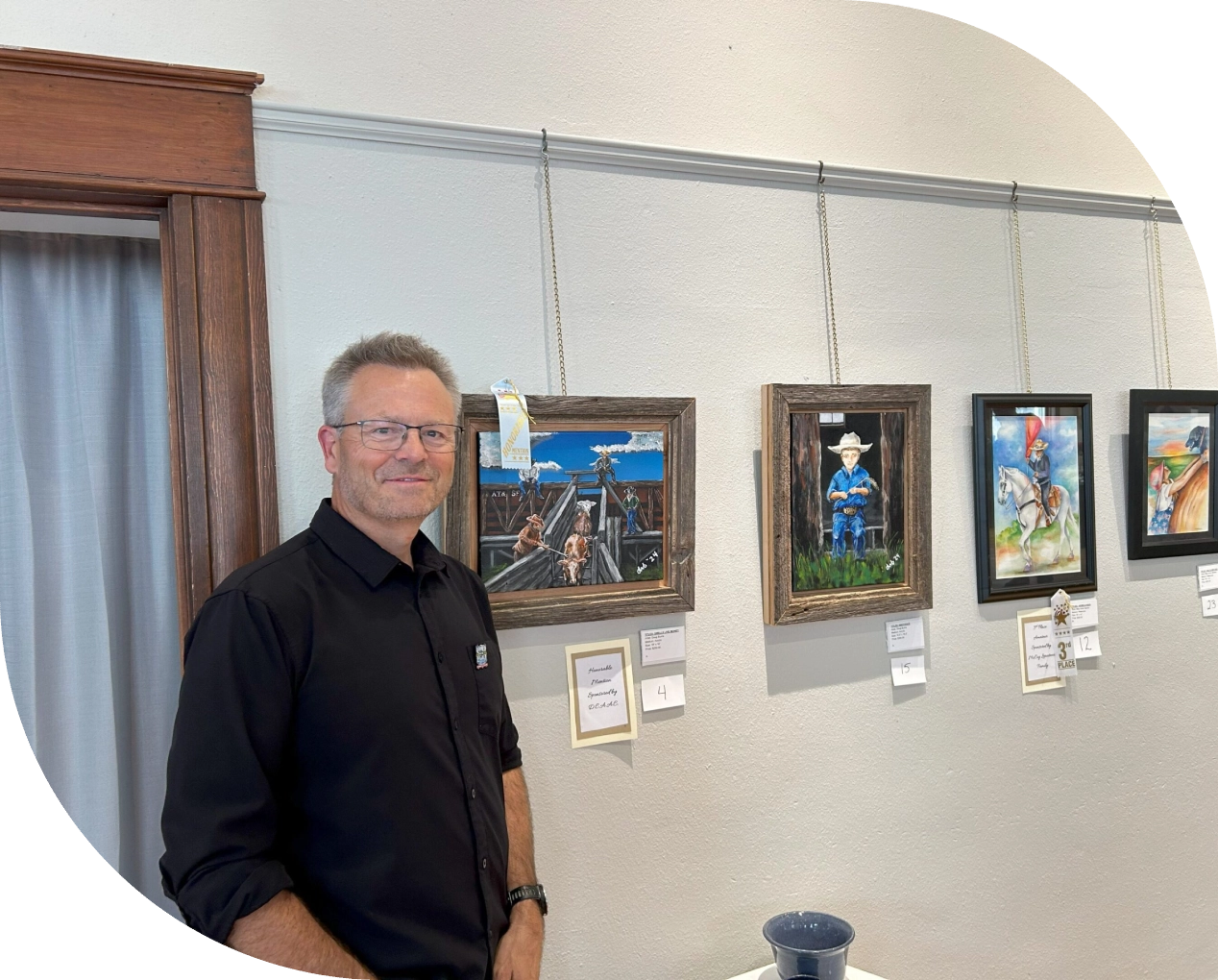 01-2 A man standing in front of some paintings